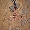 hanger met koperen infinity symbool
